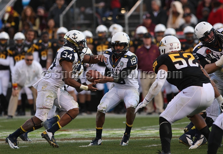 122912 Kraft SA-058.JPG - Dec 29, 2012; San Francisco, CA, USA; Navy Midshipmen quarterback Keenan Reynolds (19) hands of to full back Noah Greene (34) against the Arizona State Sun Devils in the 2012 Kraft Fighting Hunger Bowl at AT&T Park.